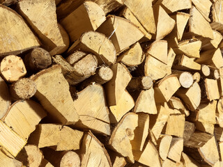 Pile stacked natural sawn wooden logs texture background. Background of cut logs close up