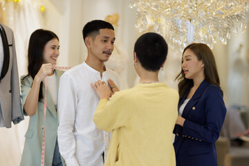 Asian couple select wedding dress in wedding studio