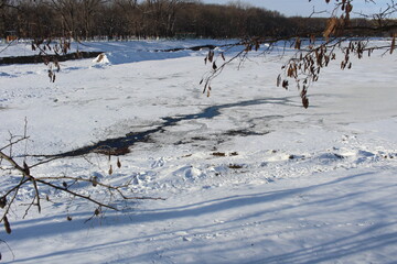 The lake is covered in ice in winter, everything is covered in snow