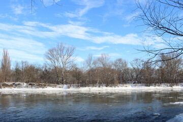 a river in winter where the ice is all covered in snow