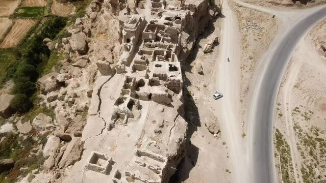 aerial view drone shot from old persian castle Izadkhast ruins of Sassanid fortress big adobe building brick mud material summer season middle east historical architecture cultural landscape in Iran