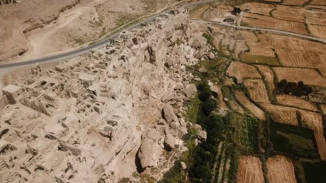 Historical town ruins of castle village large adobe city farm land field agriculture nearby silk road in middle east a complex architecture design old traditional historical local people life in Iran