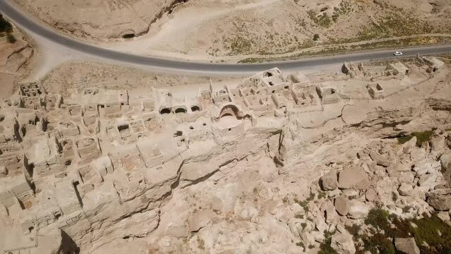 Wonderful archeology aerial drone shot old building historical village traditional ancient life in silk road side in Iran cultural landscape of settlement castle fortress in Fars Izadkhast ruins scene