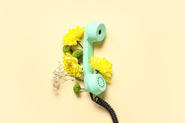 Retro telephone with beautiful gypsophila and chrysanthemum flowers on yellow background....