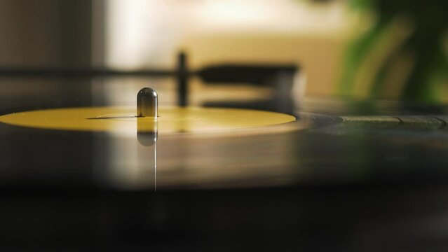Guy Turning Off a Record Player at Home in the Morning