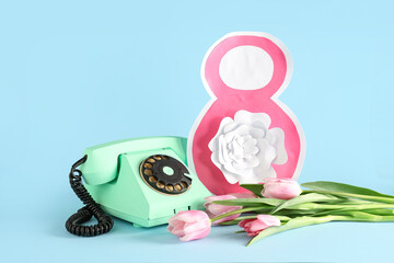 Figure 8 made of paper with retro telephone and beautiful pink tulips on turquoise background. International Women's Day