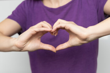 Inspire inclusion. Zoomers symbolize love. Woman finger heart dressed purple t-shirt. Hand showing...