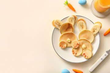 Funny Easter bunny pancakes with painted eggs on white background