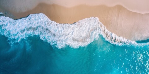 Fototapeta na wymiar Sandy beach aerial view, with soft beige sand and waves of blue