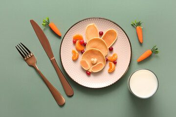 Funny Easter bunny pancakes with mandarin and berries on green background - obrazy, fototapety, plakaty