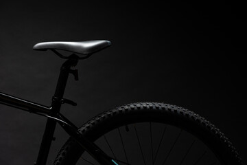 Black mountain bicycle on black background close up