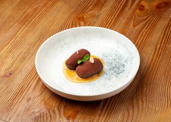 Chocolate cake on a plate on a wooden background