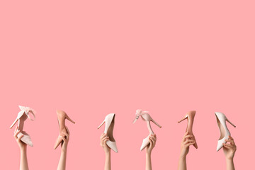 Women with stylish heels on pink background