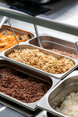 Metal trays with fresh food in a canteen