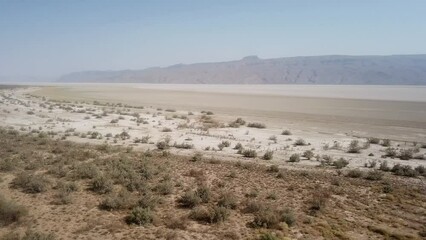 scenic wonderful aerial drone shot of drought in salt lake country side side lake in summer season flora species become dry no water climate desert hot hazy day Iran rainfed traditional agriculture