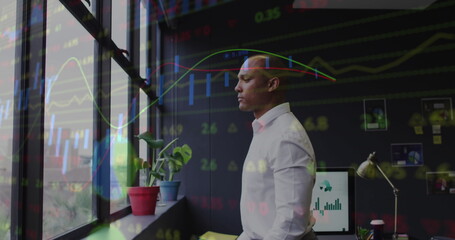 Image of financial data processing over biracial businessman in office