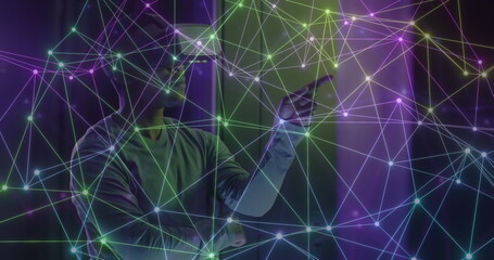 Image of network of connections over african american man using vr headset