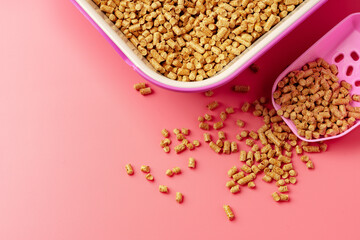 Pet litter box with bio filler on pink background