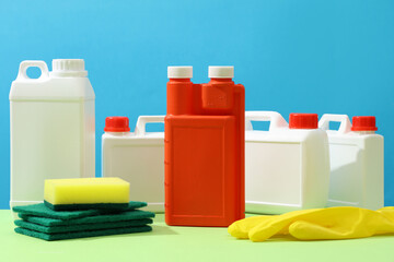 The red plastic canister stands out among other white plastic canisters and a blue background....