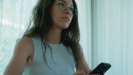 Pretty female student holding phone. Close up