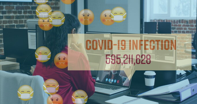 Image of emojis in face masks, number of covid 19 cases over woman using laptop on image call - Powered by Adobe