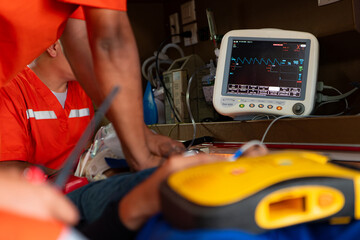 The rescue team is administering CPR to a patient who was involved in an ambulance accident. © Wosunan