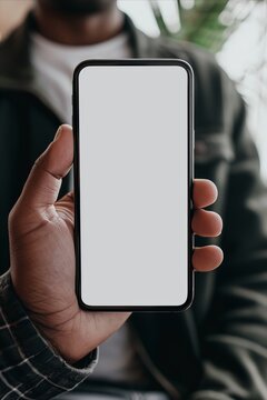 Mockup image of a smartphone with a white screen in a man's hand