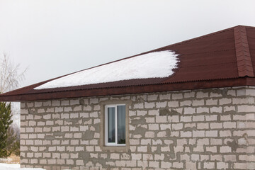 Unfinished house at a construction site in winter