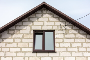 Window in the attic of a brick house