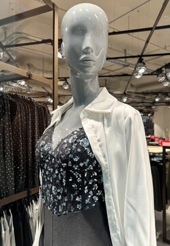 Female mannequin with clothes on display in a store