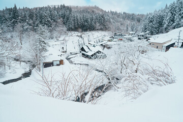 Beautiful view of Ginzan Onsen village with snow fall in winter season is most famous Japanese Hot Spring in Yamagata, Japan.