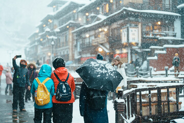 tourist in Ginzan Onsen with snow fall in winter season is most famous Japanese Hot Spring in Yamagata, Japan.