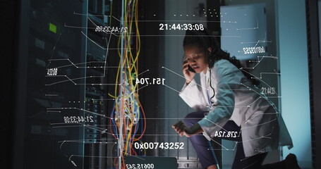 Image of changing numbers over african american woman working with smartphone and servers