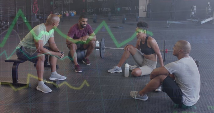 Fototapeta Image of data processing on graph over diverse fitness group sitting talking at gym