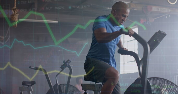Image of data processing on graph over african american man cross training on elliptical at gym