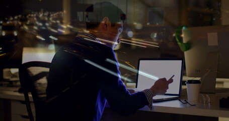 Obraz na płótnie Canvas Image of asian businessman using computer over data processing and cityscape