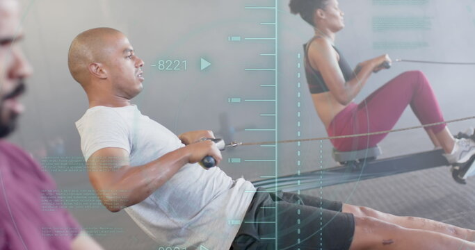 Fototapeta Image of processing data over diverse group training on rowing machines at gym