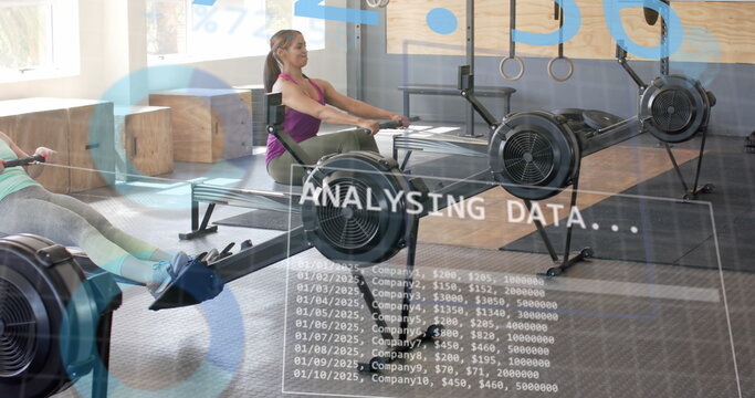 Image of interface processing data over diverse women training on rowing machines at gym - Powered by Adobe