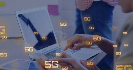 Image of 5g texts over caucasian woman using laptop