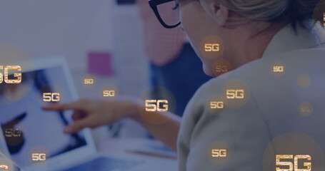 Image of 5g texts over caucasian woman using laptop