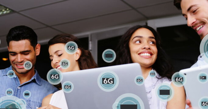 Image of 6g texts over diverse business people using technology