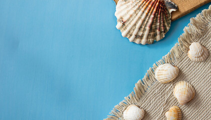 Simple and Neutral Summer Vacation Concept with Sea Shells, Jute Rug, and Linen Cloth on Beige Background. Ample Copy Space