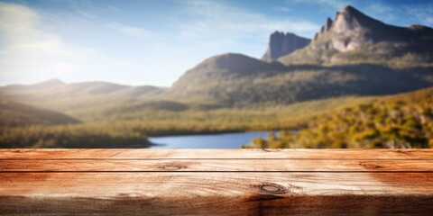 The empty wooden brown table top with blur background of Cradle mountain in Tasmania. Exuberant image. generative AI