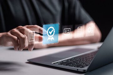 Quality assurance concept. Person use laptop with virtual high quality assurance mark for ISO certification and standardization concept. certificate, approval, compliance to requirements.