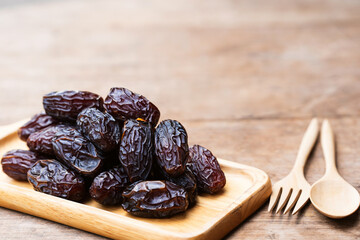 Brown dried Medjool dates are energy-dense fruits rich in many beneficial nutrients.