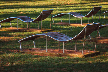 Empty sun loungers in park at sea