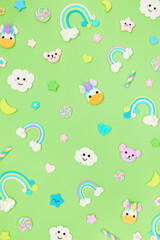 Trendy pastel green kawaii flyer, banner background design template with cute air plasticine handmade cartoon animals, unicorns, stars, rainbows pattern. Top view, flat lay. Candycore, fairycore.