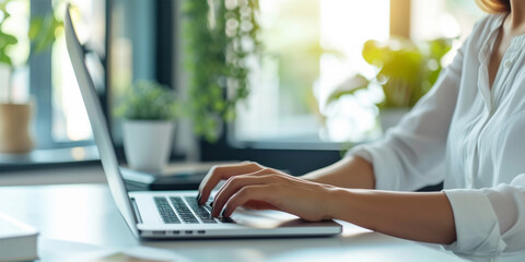 Fototapeta premium A business woman's hands expertly handle a calculator and laptop, ensuring precise calculations for financial excellence in the office.