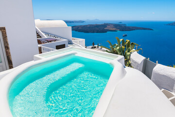 White architecture in Santorini island, Greece. Luxury swimming pool with sea view.