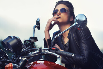 Bike, leather and woman smoking in city with sunglasses for travel, transport or road trip as...
